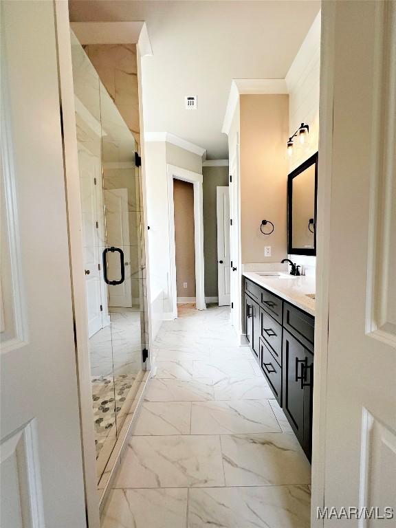 171 Mountain Laurel Rdg, Wetumpka, AL 36093 - full bathroom featuring ornamental molding, marble look tile flooring, double vanity, a stall shower, and baseboards