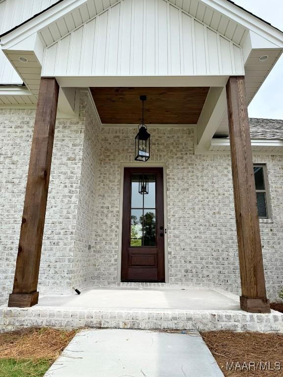 171 Mountain Laurel Rdg, Wetumpka, AL 36093 - entrance to property featuring board and batten siding, a porch, and brick siding