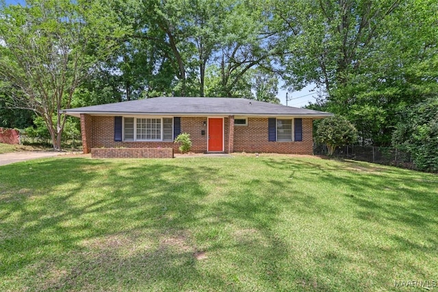 single story home with brick siding, fence, and a front yard