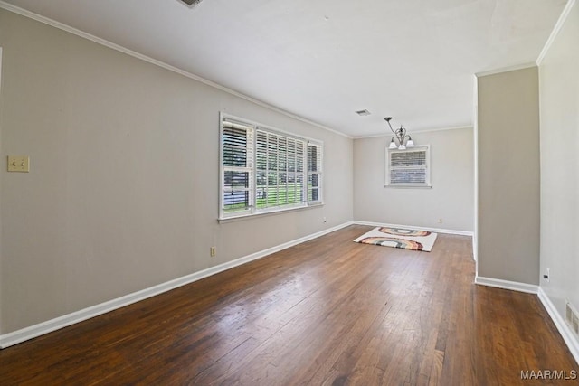 unfurnished room featuring baseboards, ornamental molding, and hardwood / wood-style flooring