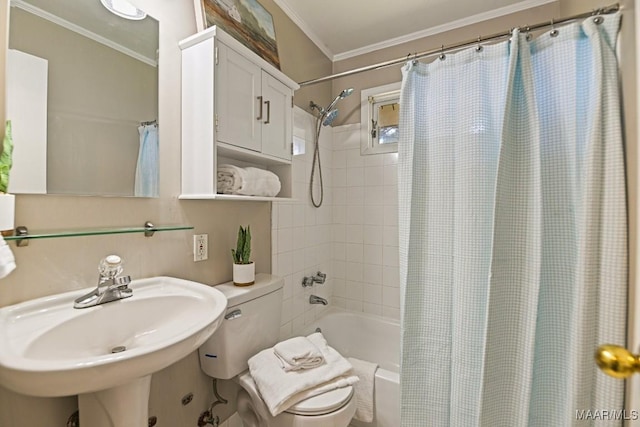 full bath with toilet, ornamental molding, a sink, and shower / tub combo