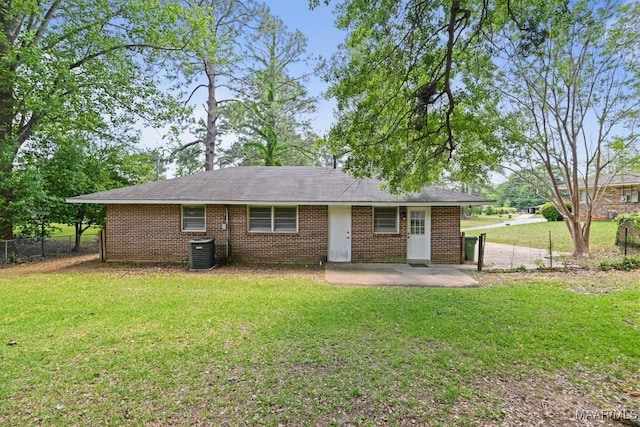 rear view of house with a patio, a lawn, and fence