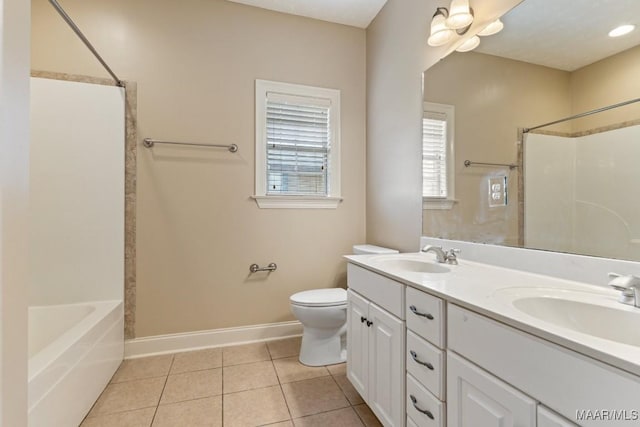 bathroom featuring a sink, baseboards, tile patterned flooring, and toilet