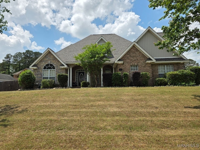 craftsman inspired home featuring board and batten siding, brick siding, and a front lawn