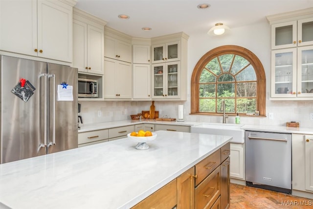 kitchen with recessed lighting, appliances with stainless steel finishes, decorative backsplash, and a sink