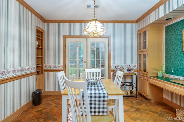 dining space with crown molding, wallpapered walls, and a chandelier