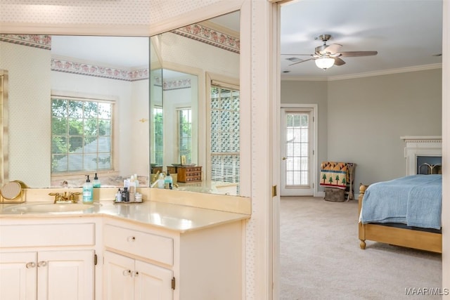 ensuite bathroom with ensuite bathroom, ornamental molding, ceiling fan, and a wealth of natural light