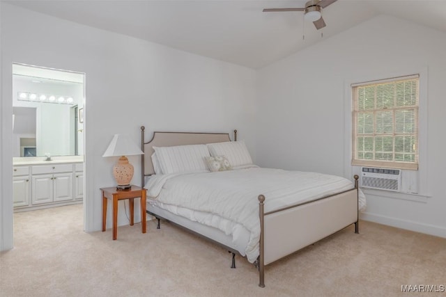 bedroom featuring connected bathroom, a sink, cooling unit, lofted ceiling, and light carpet