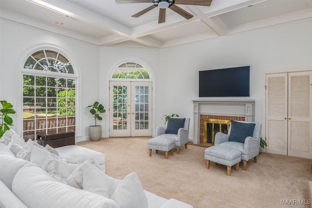 carpeted living room with ceiling fan, beam ceiling, and coffered ceiling