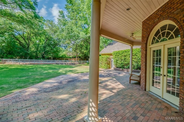 view of patio / terrace featuring a fenced backyard, ceiling fan, and french doors