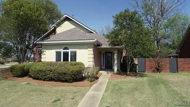 bungalow-style home featuring fence and a front yard
