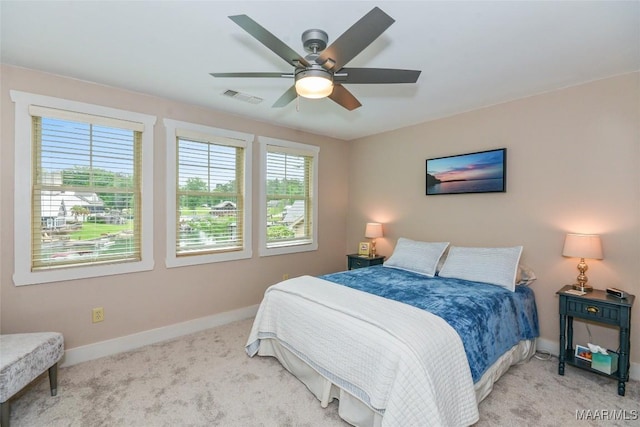 bedroom featuring baseboards, carpet, a ceiling fan, and visible vents