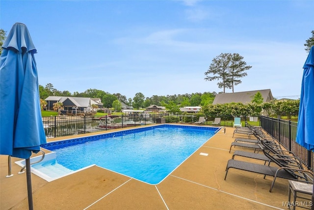 view of pool with fence, a fenced in pool, and a patio area