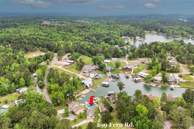 bird's eye view with a water view and a wooded view
