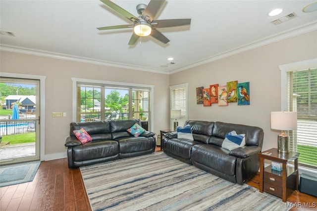 living room with wood-type flooring, ceiling fan, visible vents, and a healthy amount of sunlight