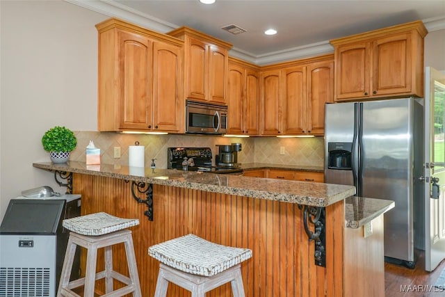 kitchen featuring crown molding, stainless steel appliances, recessed lighting, a peninsula, and stone counters
