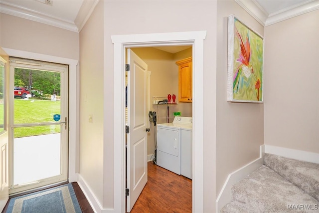 laundry area featuring baseboards, ornamental molding, cabinet space, and washer and dryer