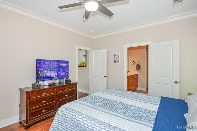 bedroom with visible vents, ornamental molding, baseboards, and wood finished floors