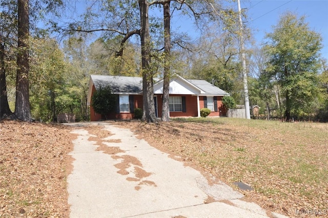 view of front facade with fence and driveway