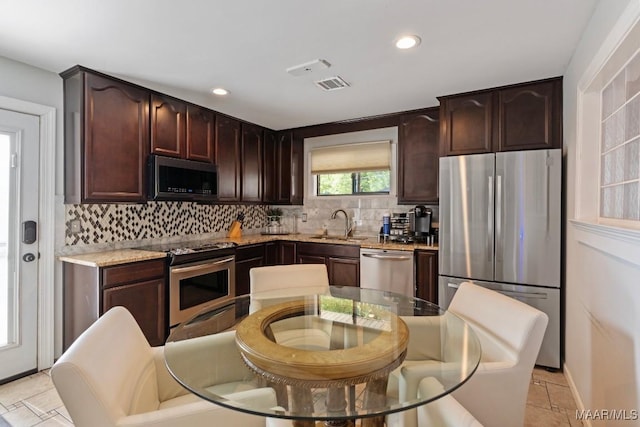 kitchen with visible vents, decorative backsplash, dark brown cabinetry, recessed lighting, and stainless steel appliances