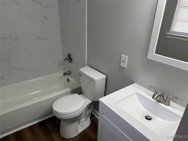 full bath featuring vanity, wood finished floors, toilet, and shower / washtub combination