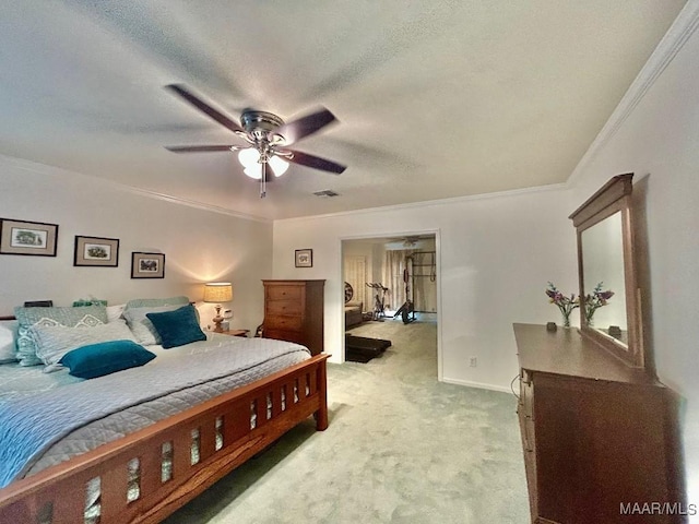 bedroom featuring ceiling fan, light colored carpet, a textured ceiling, visible vents, and ornamental molding