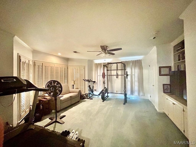 workout room featuring carpet floors, ornamental molding, a textured ceiling, and ceiling fan