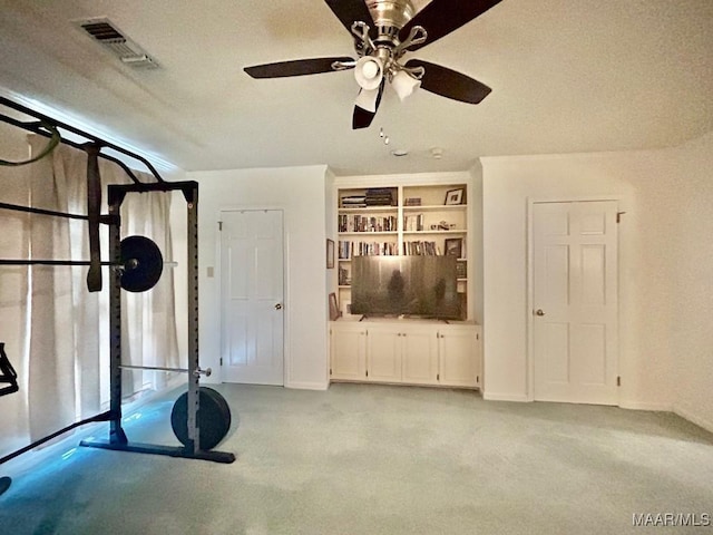workout area with visible vents and a ceiling fan