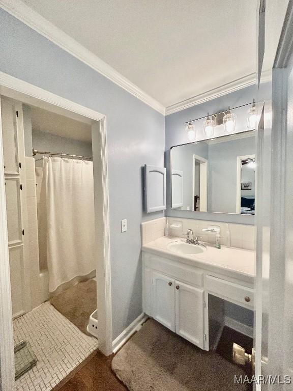 bathroom with a shower with curtain, ornamental molding, and vanity