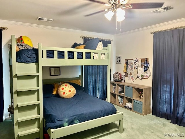 carpeted bedroom with crown molding, a ceiling fan, and visible vents
