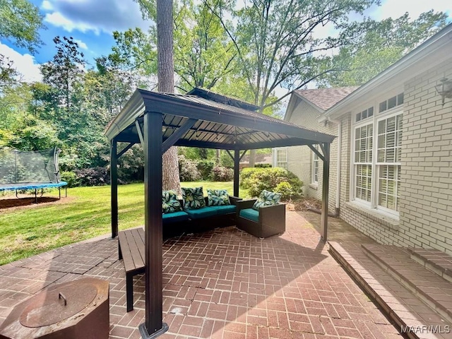 view of patio / terrace featuring a gazebo, an outdoor living space, and a trampoline