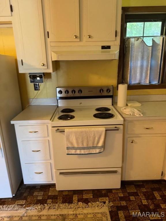 3008 Baffin Dr, Montgomery, AL 36110 - kitchen featuring light countertops, white cabinets, freestanding refrigerator, white electric range oven, and under cabinet range hood