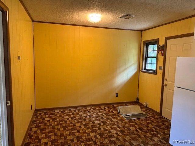 3008 Baffin Dr, Montgomery, AL 36110 - spare room featuring crown molding, wooden walls, a textured ceiling, baseboards, and visible vents