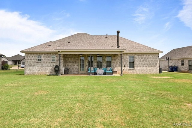 back of property featuring roof with shingles, brick siding, outdoor lounge area, a patio area, and a lawn