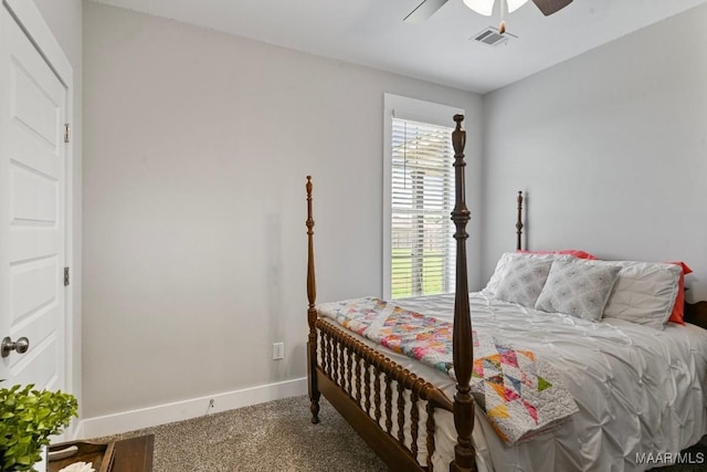 carpeted bedroom with baseboards, a ceiling fan, and visible vents