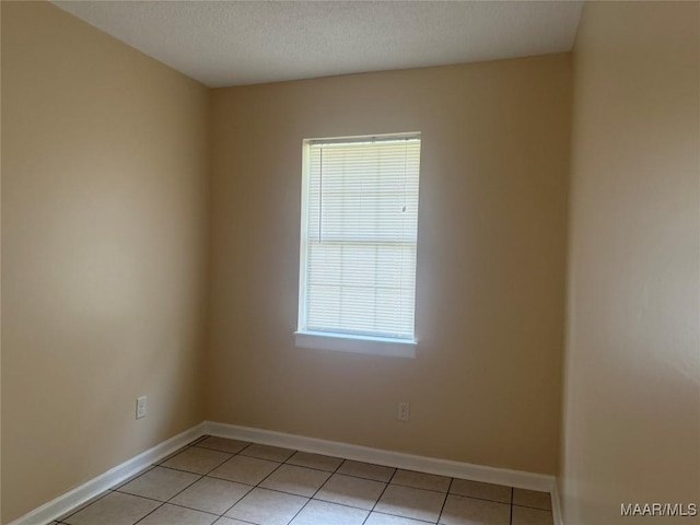 6253 S Hampton Dr, Montgomery, AL 36116 - unfurnished room with baseboards, a textured ceiling, and light tile patterned flooring