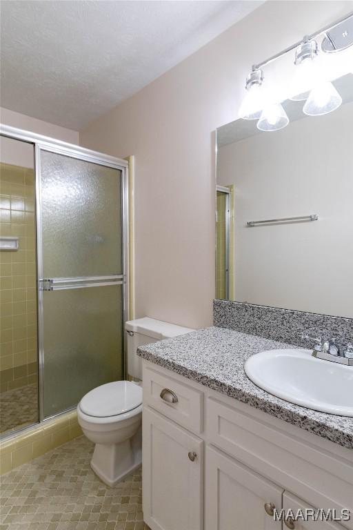 206 Choctaw Dr, Montgomery, AL 36117 - full bathroom featuring a shower stall, toilet, tile patterned flooring, and vanity