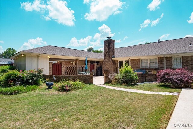 206 Choctaw Dr, Montgomery, AL 36117 - ranch-style house with a front yard, a chimney, and brick siding
