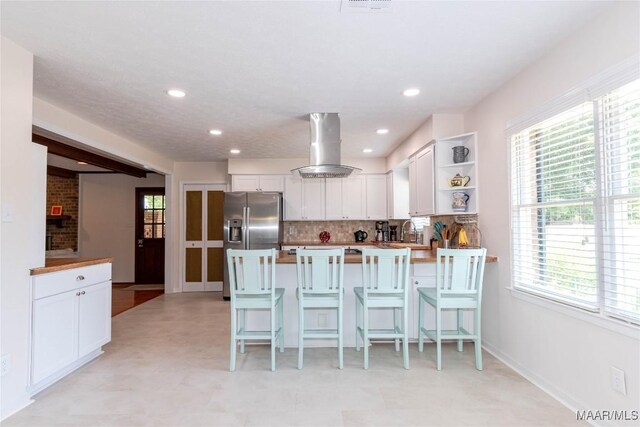 206 Choctaw Dr, Montgomery, AL 36117 - kitchen featuring island range hood, white cabinetry, plenty of natural light, a peninsula, and recessed lighting