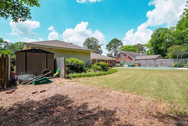 view of yard featuring a fenced in pool, a shed, an outbuilding, and fence