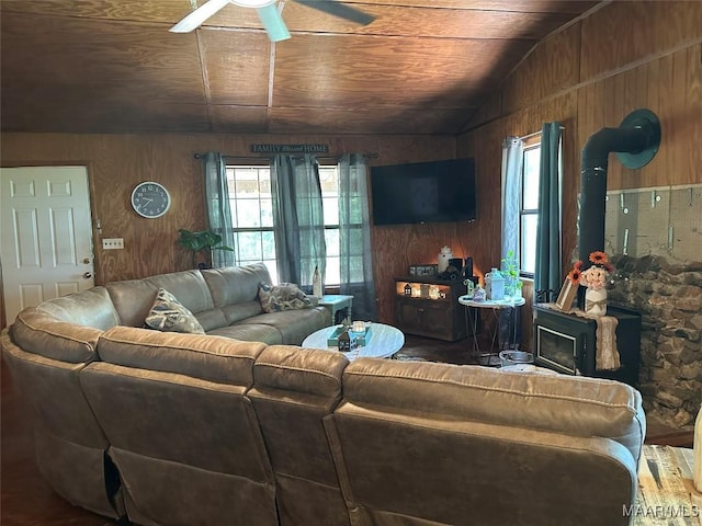 1551 Barnesville Loop, Dadeville, AL 36853 - living area featuring wooden walls, ceiling fan, a wood stove, lofted ceiling, and wood ceiling