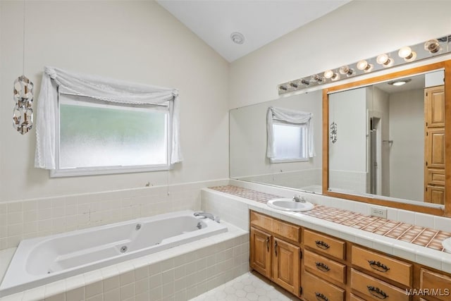 1520 Meriwether Rd, Montgomery, AL 36117 - bathroom with a tub with jets, vanity, and lofted ceiling