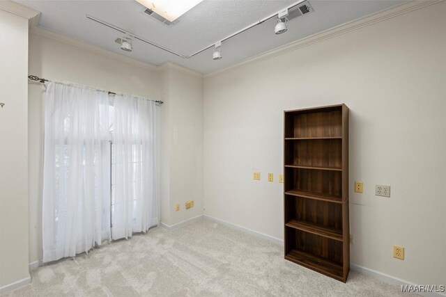 1520 Meriwether Rd, Montgomery, AL 36117 - carpeted empty room with rail lighting, ornamental molding, and baseboards