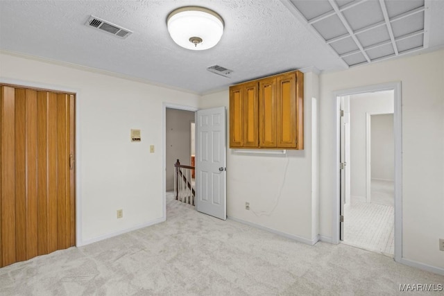 1520 Meriwether Rd, Montgomery, AL 36117 - unfurnished bedroom featuring light carpet, a textured ceiling, and baseboards