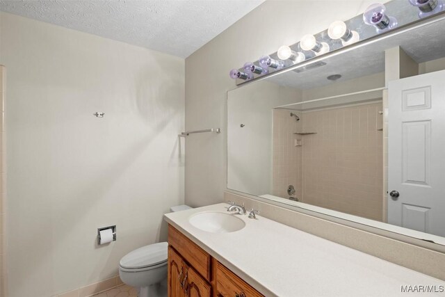 1520 Meriwether Rd, Montgomery, AL 36117 - bathroom with toilet, vanity, a shower, a textured ceiling, and tile patterned flooring