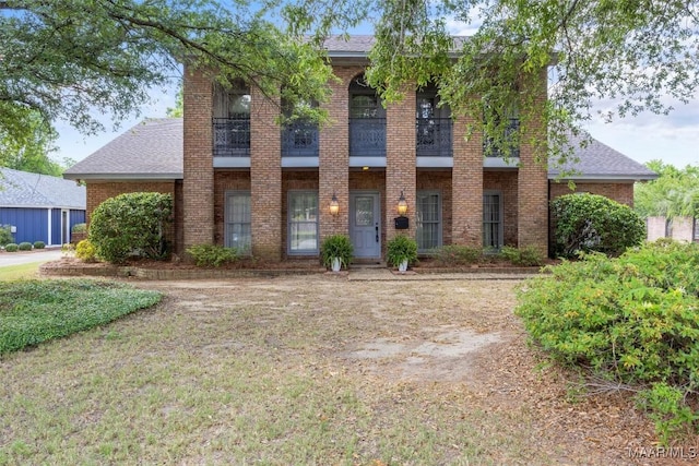 1520 Meriwether Rd, Montgomery, AL 36117 - view of front of property with a balcony, brick siding, and a shingled roof