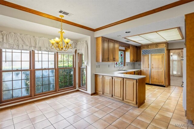 1520 Meriwether Rd, Montgomery, AL 36117 - kitchen with paneled fridge, a chandelier, light countertops, light tile patterned flooring, and a peninsula