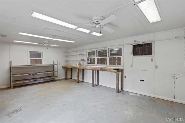 1520 Meriwether Rd, Montgomery, AL 36117 - miscellaneous room featuring ceiling fan, a wall mounted AC, unfinished concrete floors, and a workshop area