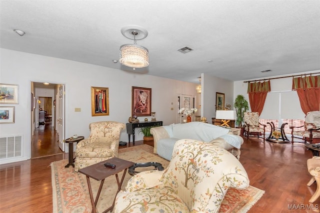 3146 Malone Dr, Montgomery, AL 36106 - living room with visible vents, a textured ceiling, and wood finished floors