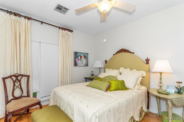 3146 Malone Dr, Montgomery, AL 36106 - bedroom featuring visible vents, a baseboard radiator, light wood-style flooring, and a ceiling fan